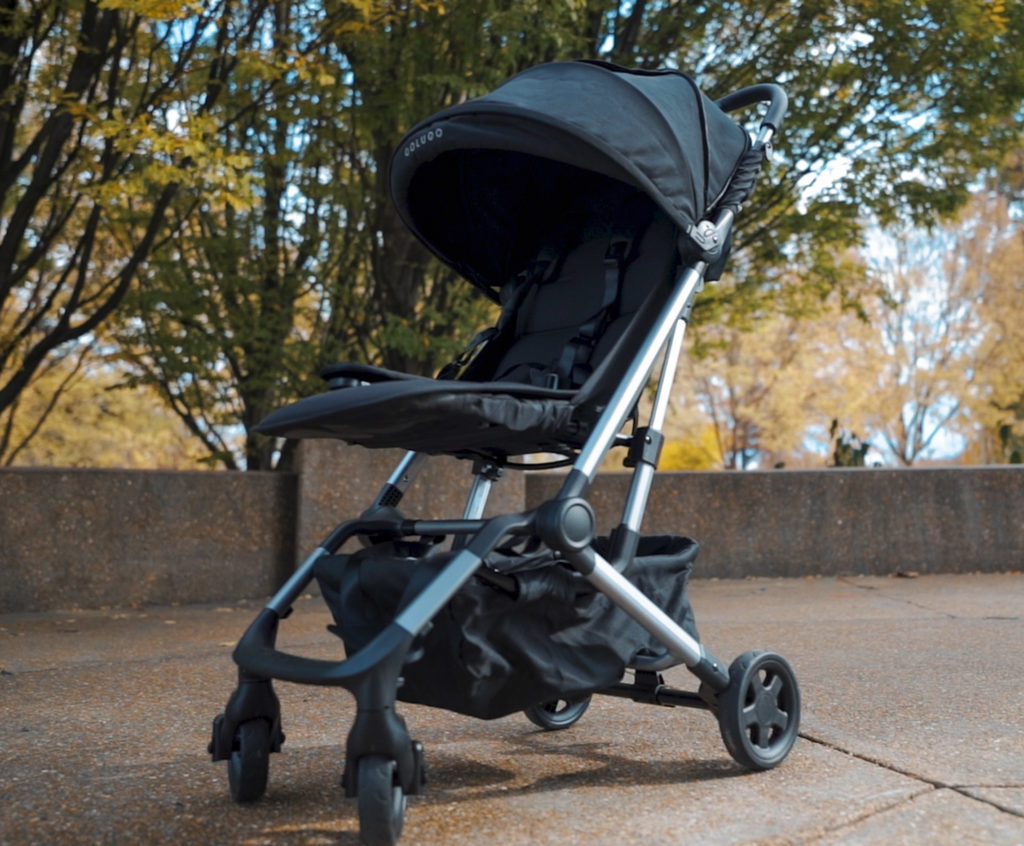 The Colugo Compact stroller on a park sidewalk